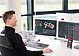 Man in black shirt sitting in front of screen and choosing an industrial gear unit